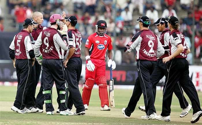 Somerset's Bowler Charl Willoughby celebrates with teammates after taking the wicket of Trinidad and Tobago's William Perkins during their Champions League T20 match at Chinnaswamy Stadium in Bangalore on Monday. (PTI Photo) CLT20: T&T vs Somerset
