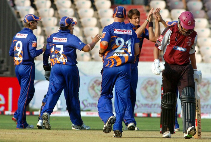 AV Suppiah Somerset of Somerset returns to pavilion after losing his wicket as Eagles' De Villiers celebrate with teammates at the Champions League Twenty20 match at Rajiv Gandhi International Cricket Stadium in Hyderabad on Friday. (PTI Photo) CLT20: Somerset vs Eagles