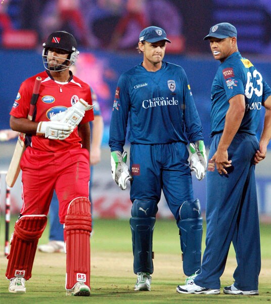 Deccan Chargers' Adam Gilchrist and Andrew Symnods celebrate the wicket of Trinidad and Tobago's Daren Ganga during their Champions League T20 match in Hyderabad. (PTI Photo) CLT20: DC vs TT