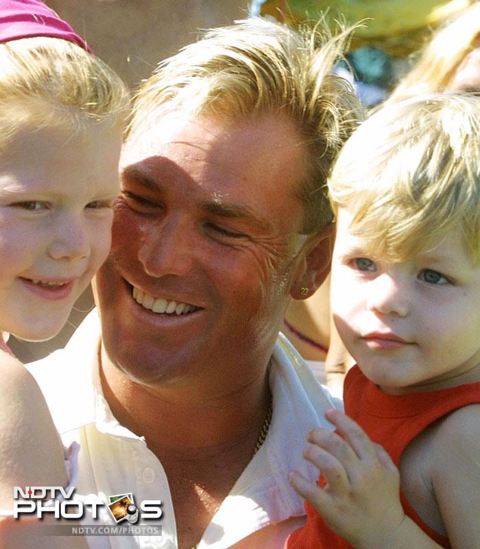 Warne hugs his children Brooke (L), and Jackson.