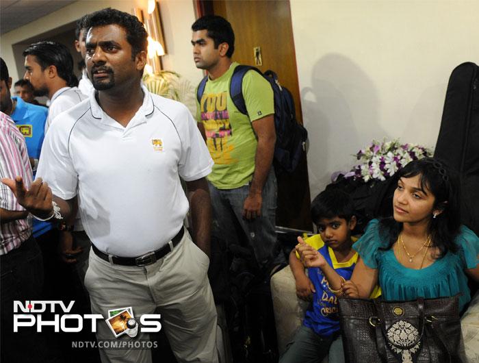 Muttiah Muralitharan (L) with his son Naren (2R) and wife Madhi Malar in April 2011.