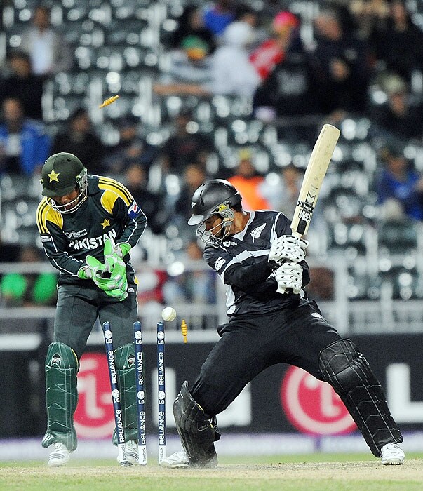 New Zealand's Ross Taylor watches his bails go in air after being clean bowled by Pakistan's Shahid Afridi as wicket-keeper Kamran Akmal looks on during their ICC Champions Trophy's second semi-final match at The New Wanderers Stadium in Johannesburg on Saturday. (AFP Photo) CT semis: Pak vs NZ, Match 14