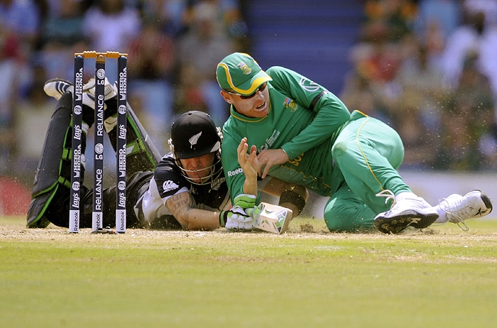 New Zealand's Brandon McCullum collides with South African fielder Johan Botha during their ICC Champions Trophy group match at Supersport Park in Centurion on Thursday. (AFP Photo) CT: SA vs NZ, Match 3