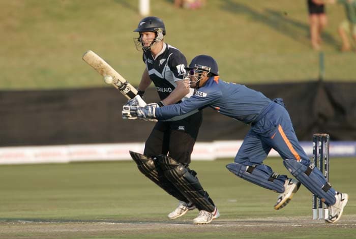 India's captain Mahendra Singh Dhoni tries to catch a ball batted by New Zealand's lan Butler, background, during a warm up match between India and New Zealand ahead of the Champions Trophy at Potchefstroom. (AP Photo) CT: Ind vs NZ warm-up tie