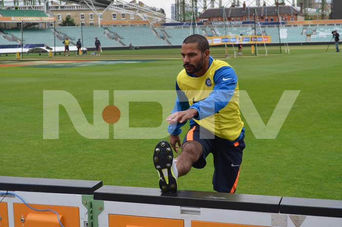 Dhawan does a stretch to loosen up during the training session. ICC Champions Trophy: Team India gear up for clash against West Indies