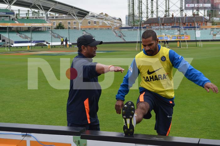 A team instructor gives Dhawan tips to exercise as the team trains at The Oval. ICC Champions Trophy: Team India gear up for clash against West Indies