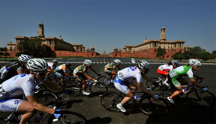 Cyclists ride past the Indian Presidential Palace during the Women's 112km Road Race Cycling in New Delhi. (AFP Photo)