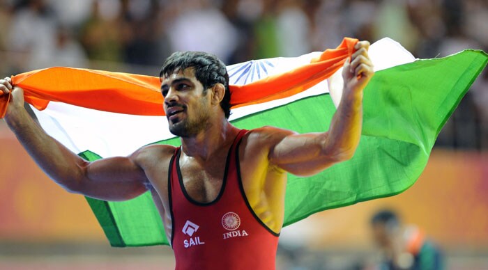 India's Sushil Kumar (R) celebrates after defeating South Africa's Heinrich Barnes during the men's 66 kg wrestling gold medal match at the Commonwealth Games 2010 in New Delhi. Indian world champion Sushil Kumar delighted an expectant home crowd with a gold in the Commonwealth Games freestyle wrestling 66kg. (AFP Photo)