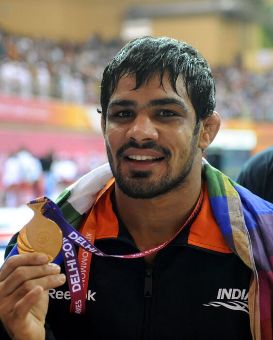 India's Sushil Kumar poses with his gold medal during the men's 66kg freestyle wrestling awards ceremony during the Commonwealth Games in New Delhi. (AFP Photo)
