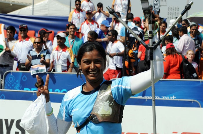 India's Deepika Kumar celebrates defeating England's Alison Jane Williamson during the Archery Women's Individual at the Commonwealth Games in New Delhi. Kumari, aged just 16, beat Williamson in the match for gold, with India also taking bronze when Dola Banerjee beat Malaysia's Anbarasi Subramaniam in the match for third place. (AFP Photo)