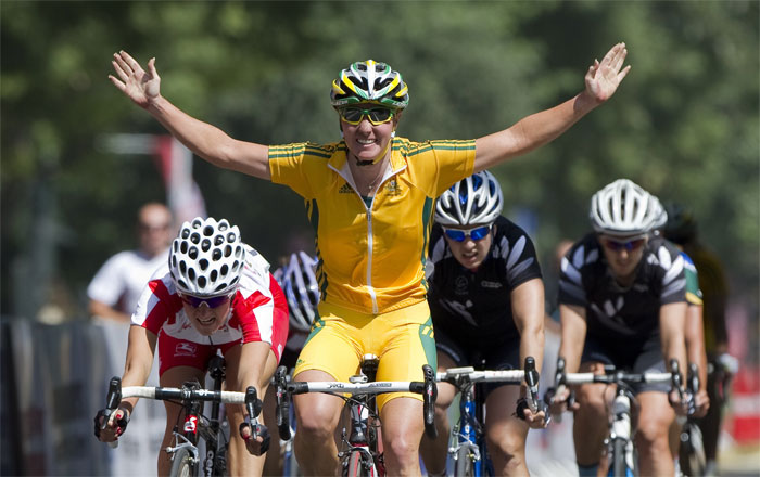 Australia's Rochelle Gilmore crosses the finishing line first in the Women's 112km Road Race Cycling event in New Delhi. Australia's Rochelle Gilmore won the gold medal in the women's road race at the Commonwealth Games on Sunday. England's Elizabeth Armitstead took silver with Chloe Hosking of Australia winning the bronze. (AFP Photo)