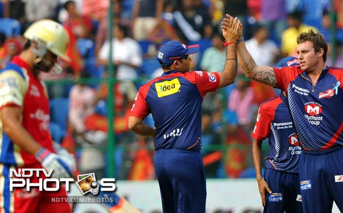 Virat Kohli (l) also left the field and his eight runs was a poor reflection on his brilliant form, coming into IPL. (AFP PHOTO/Manjunath KIRAN) IPL 5: Bangalore ease past Delhi
