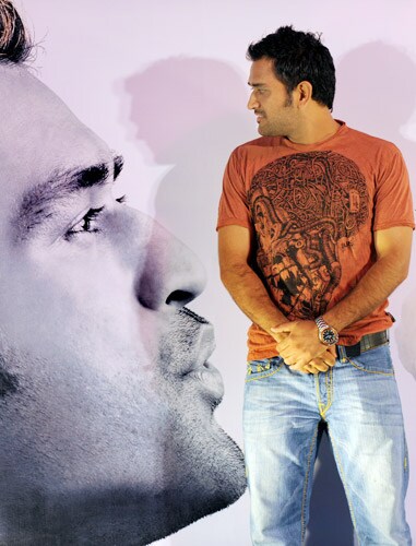 The shadow of Mahendra Singh Dhoni falls upon an advertising campaign board as he announces the details of the city's second Fashion Week in Kolkata. (AFP Photo) Dhoni's fashion statement