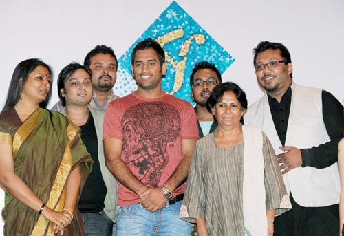 Mahendra Singh Dhoni poses with designers for a photo during the launch of the second season of Kolkata Fashion Week in Kolkata. (PTI Photo) Dhoni's fashion statement