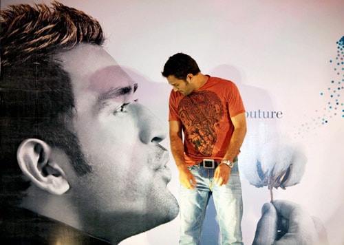 Mahendra Singh Dhoni stands in front of his life size poster during the launch of the second season of Kolkata Fashion Week in Kolkata. (PTI Photo) Dhoni's fashion statement