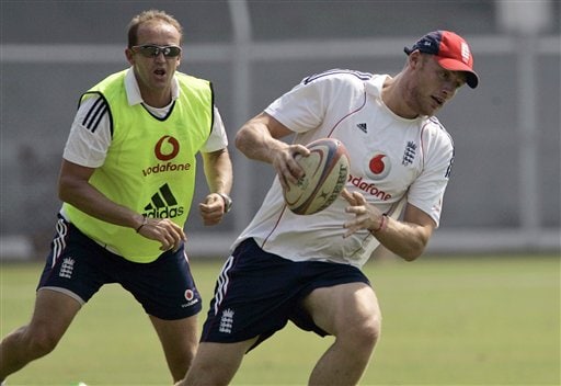 Andrew Flintoff (right) runs with a rugby ball, as assistant coach Andy Flower chases him during a practice session in Mumbai on Saturday, November 8, 2008. (AP Photo) England prepare for India battle