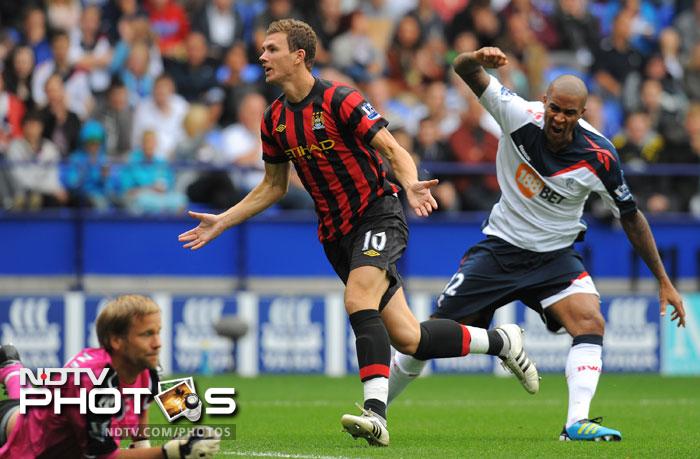 Manchester City's Bosnian forward Edin Dzeko celebrates after scoring his teams third goal. (AFP Photo) EPL 2011: Match-Week 2