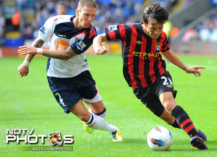 Manchester City found their big money signings shining yet again as they scored thrice through Edin Dzeko, David Silva and Gareth Barry to knock out a fighting Bolton side. (AFP Photo) EPL 2011: Match-Week 2