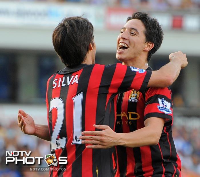 Manchester City's French midfielder Samir Nasri (R) celebrates with Spanish midfielder David Silva (L) after scoring the third goal against Blackburn. (AFP Photo) EPL 2011: Match-Week 7