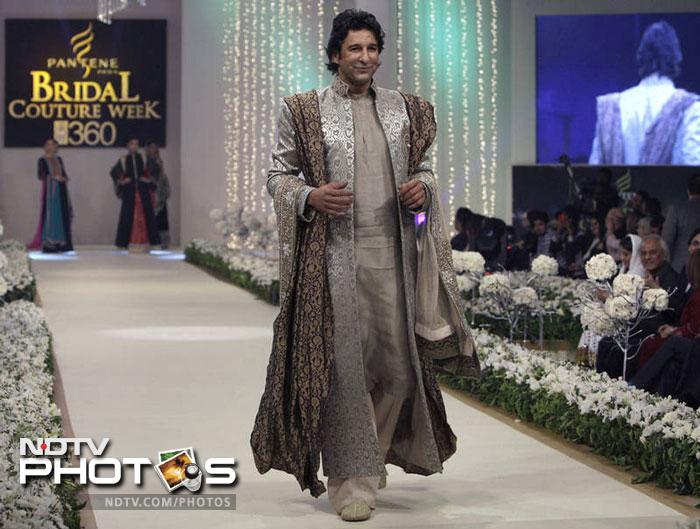 Wasim Akram looks at ease as he glides down the ramp in his loud attire for the Pantene Bridal Couture Week.