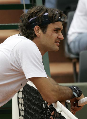 Top-seeded Roger Federer, of Switzerland, rests at the net during a training session on Thursday at the Roland Garros stadium in Paris. The French Open tennis tournament starts on Sunday. French Open 2008