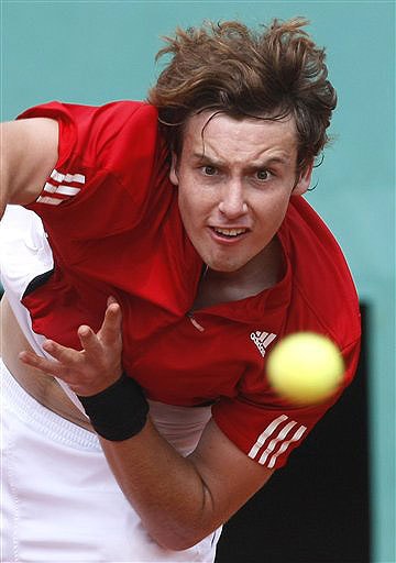 Latvia's Ernest Gulbis serves the ball to France's Michael Llodra during their fourth round match of the French Open on June 1, 2008. (AP Photo) French Open 2008, Day 8