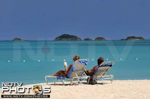 A couple soaks up the sun close to where the two cricketers were present. A serene setting with clear blue waters is what defines a holiday here. (AFP Photo) Not just cricket