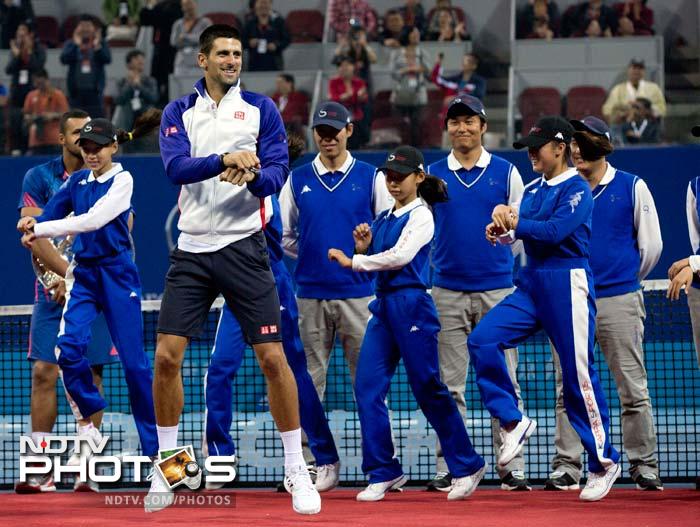 The ball boys and girls also join in as Novak goes the 'Gangnam' way and puts on a show for the crowd in Beijing.