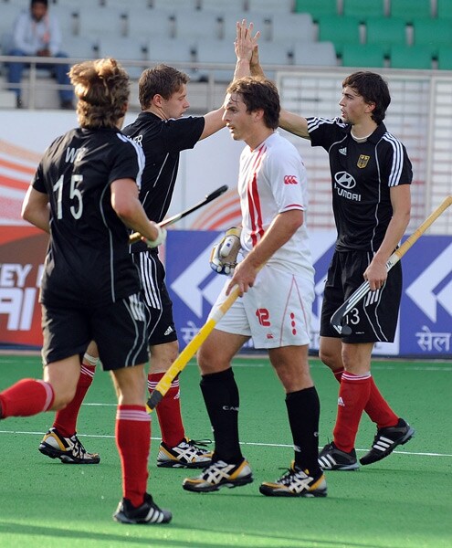 Canadian hockey player David Jameson watches as German hockey player Tobias Hauke celebrates a goal with teammates during their World Cup 2010 match at The Major Dhyan Chand Stadium in New Delhi. (AFP Photo) Germany rout Canada