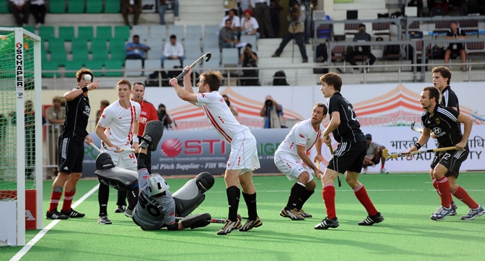 German hockey players Jan-Marco Montag and Matthias Witthaus watch as Canadian hockey players make an unsuccessful attempt to stop a goal during their World Cup 2010 match at the Major Dhyan Chand Stadium in New Delhi. (AFP Photo) Germany rout Canada