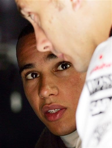British McLaren-Mercedes driver Lewis Hamilton looks at a mechanic at the team's garage at the end of a practice session for Sunday's Formula One Chinese Grand Prix at Shanghai International Circuit in Shanghai. Hamilton is being investigated by Formula One's governing body for his role in an accident during his victory in last week's Japanese Grand Prix. Hamilton awaits verdict