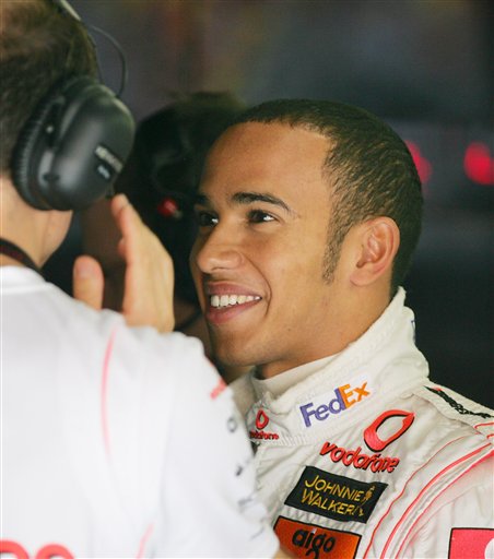 Hamilton chats with a mechanic at the team's garage during the practice session. Hamilton awaits verdict