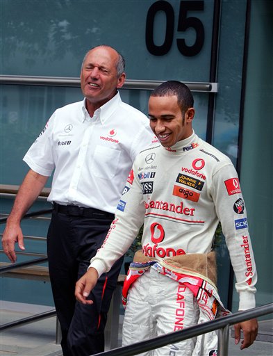 Ron Dennis, left, and Hamilton walk together toward their team's garage for the practice session. Hamilton awaits verdict