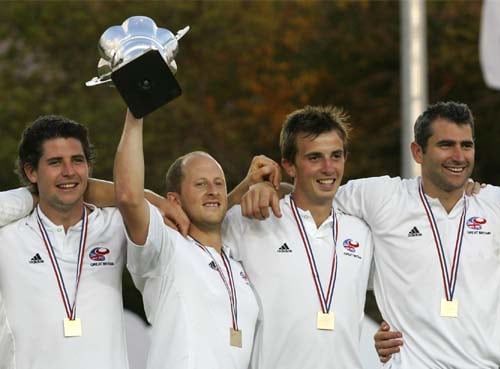 Great Britain's captain Ben Hawes raises the championship trophy accompanied by teammates (from left) Simon Mantell, Matt Daly and Richard Mantell after defeating India 2-0 in the final game of hockey Olympic qualifiers in Santiago on Sunday. India lose hockey qualifier