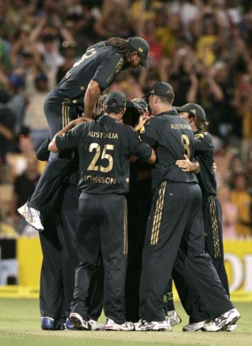 Andrew Symonds, left, jumps onto his huddled teammates after they defeated India in their one-day international cricket match at the Adelaide Oval on Sunday, February 17, 2008. Australia won by 50 runs after India are all out for 153. 7th Match: India vs Australia