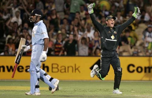 Adam Gilchrist, right, celebrates after he caught out Robin Uthappa, left, for 18 runs in their one-day international cricket match at the Adelaide Oval on Sunday, February 17, 2008. Australia made 203 in their innings. 7th Match: India vs Australia