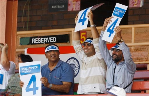 Indian cricket fans hold up score cards during their Women's World Cup cricket match between India and Australia at North Sydney Oval.(AP Photo) WWC: India beat Aus by 16 runs