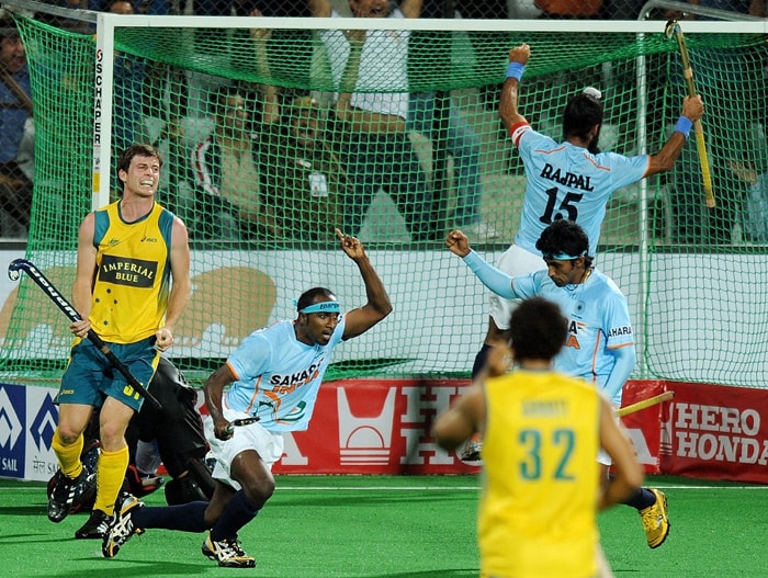 Indian hockey player Vikram Pillay (2L) celebrates after scoring against Australia during their World Cup 2010 match at the Major Dhyan Chand Stadium in New Delhi. (AFP Photo) Australia beat India 5-2