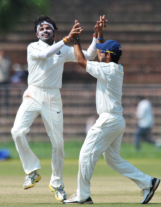 Santhakumaran Sreesanth and Piyush Chawla celebrate the wicket of during the second day of the three-day practice match between Australia and the Indian Board President's XI in Chandigarh. (AFP Photo) Australia vs Board President's XI