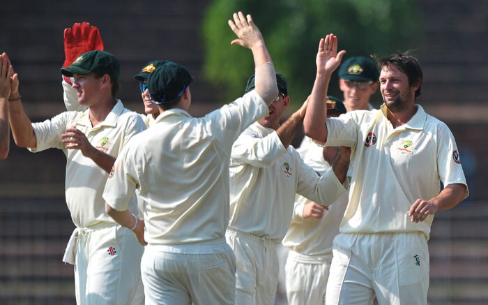 Ben Hilfenhaus celebrates with teammates the wicket of Ajinkya Rahane during the second day of the three-day practice match between Australia and the Indian Board President's XI in Chandigarh. (AFP Photo) Australia vs Board President's XI