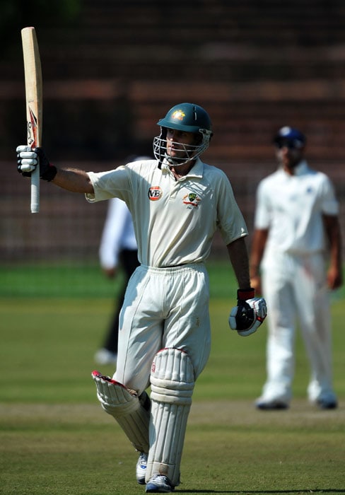 Simon Katich celebrates after scoring a century (100 runs) during the first day of the three-day practice match against the Indian Board President's XI in Chandigarh. (AFP Photo) Australia vs Board President's XI