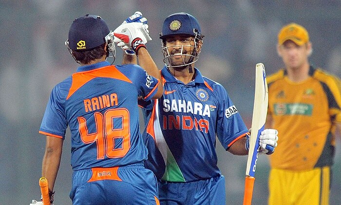 India captain Mahendra Singh Dhoni (C) celebrates their victory with Suresh Raina (L) during the 3rd ODI match between Indian and Australia at Ferozshah Kotla cricket stadium in New Delhi on Saturday, October 31, 2009. India won by 6 wickets. (AFP Photo) 3rd ODI: India vs Australia
