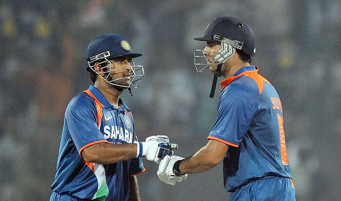 India skipper Mahendra Singh Dhoni congratulates teammate Yuvraj Singh after he hit a six during their 3rd ODI match against Australia in New Delhi on Saturday. (AFP Photo) 3rd ODI: India vs Australia
