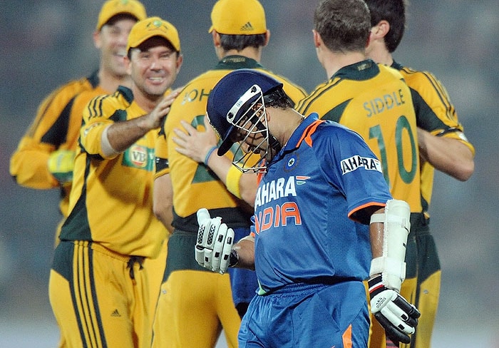 Australian cricketers celebrate the run out of India's Sachin Tendulkar during the 3rd ODI match in New Delhi on Saturday. (AFP Photo) 3rd ODI: India vs Australia