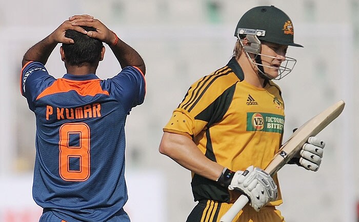 Australia's Shane Watson takes a run as India's Praveen Kumar reacts during the fourth ODI match at Mohali on Tuesday. (AFP Photo) Australia bounce back against India