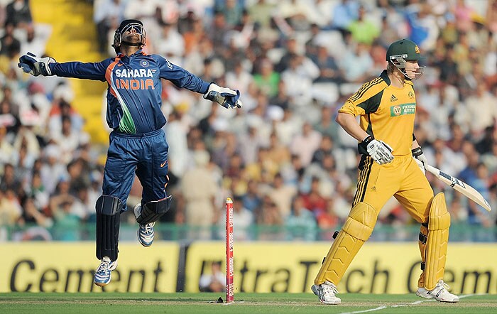 India captain Mahendra Singh Dhoni reacts after taking the catch to dismiss Australia's Shane Watson during the fourth ODI match at Mohali on Tuesday. (AFP Photo) Australia bounce back against India