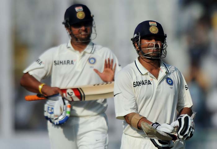 Sachin Tendulkar walks back to the dressing room after losing his wicket on his score of 98 runs, as teammate Suresh Raina applauds during the third day of the opening Test between India and Australia in Mohali. (AFP Photo) IND vs AUS: 1st Test, Day 3