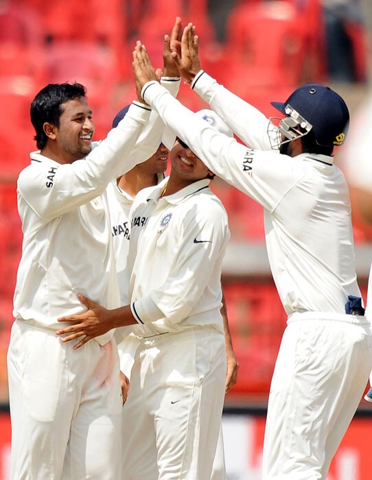 Pragyan Ojha celebrates with teammates after taking the wicket of Shane Watson during the fourth day of the second Test between India and Australia at M. Chinnaswamy Stadium in Bangalore. (AFP Photo) IND vs AUS: 2nd Test, Day 4