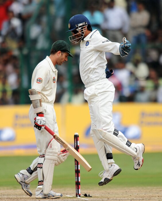 Mahendra Singh Dhoni jumps in the air to celebrate the wicket of Australian batsman Simon Katich during the fourth day of the second Test between India and Australia at M. Chinnaswamy Stadium in Bangalore. (AFP Photo) IND vs AUS: 2nd Test, Day 4
