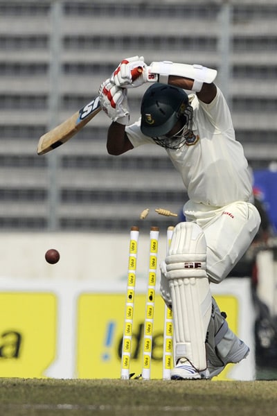 Raqibul Hasan is bowled by Zaheer Khan during the fourth day of the second Test match in Dhaka. (AFP Photo) India win Test series